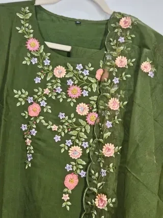 Off-white pure muslin lehenga with intricate pink and purple floral embroidery, ideal for weddings and festive occasions