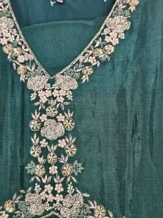 Handcrafted pure chinon Anarkali gown in deep green with intricate gold floral embroidery on the neckline and bodice.