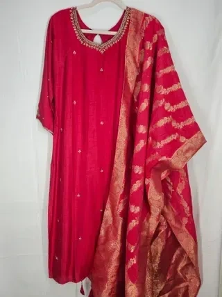 Gold Dola silk gown with intricate embroidery, featuring a matching dupatta with gold zari patterns, ideal for weddings.