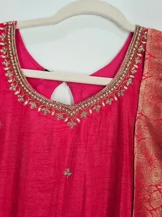 Gold Pure Dola silk gown with intricate gold embroidery on the neckline, paired with a matching brocade dupatta, ideal for weddings.