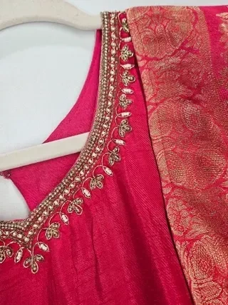 Gold pure Dola silk gown with intricate zari embroidery and sequin detailing, perfect for Indian weddings and festivals