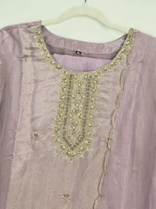 Handcrafted pure tissue silk gown in soft lavender with intricate gold embroidery, perfect for Indian weddings and festivities