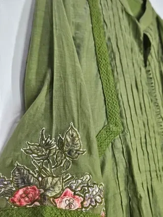 Pastel green Chanderi silk suit set with delicate floral embroidery on the sleeve and pintuck detailing on the front.