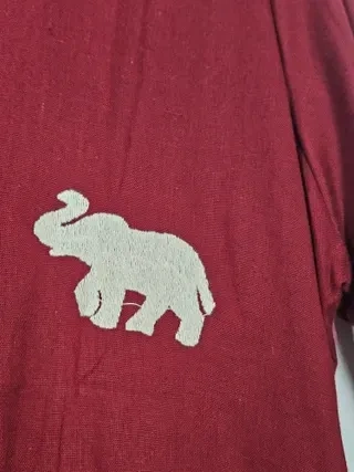 Handcrafted mul cotton ethnic frock in deep maroon with cream elephant embroidery, perfect for festive occasions.