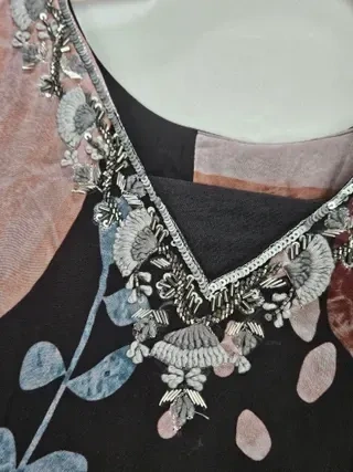 Handcrafted pure georgette Indian wedding lehenga gown with intricate silver embroidery on a multicolor floral fabric.