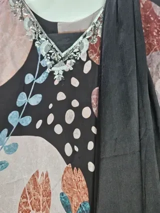 Handcrafted pure georgette Indian wedding lehenga gown with silver embroidered neckline, floral and leaf patterns, and matching dupatta.