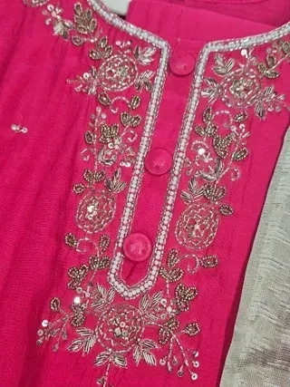Ivory muslin Anarkali gown featuring intricate gold and silver floral embroidery with sequins on the neckline.