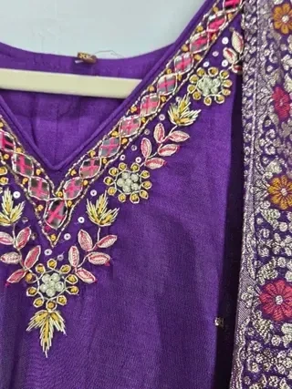 Jewel-toned purple pure Dola silk gown with intricate floral embroidery and beadwork, perfect for weddings and festivals