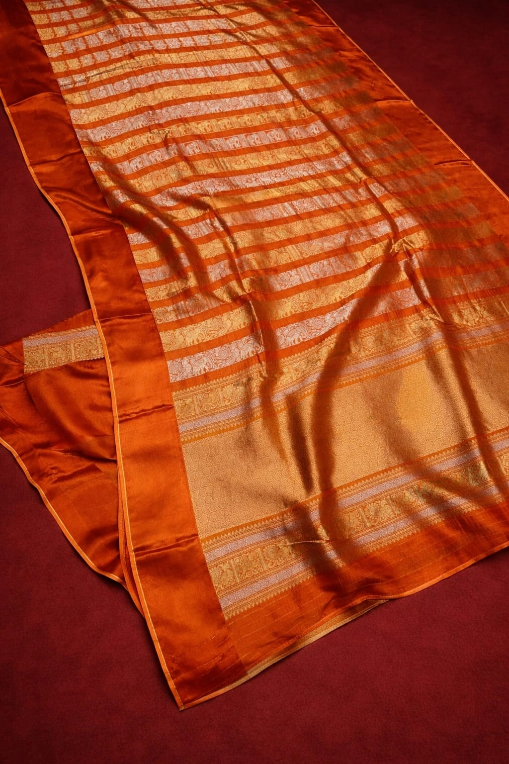 Luxurious pure Russian crape beige saree with golden and copper stripes, elegant sheen, perfect for weddings and festivals.