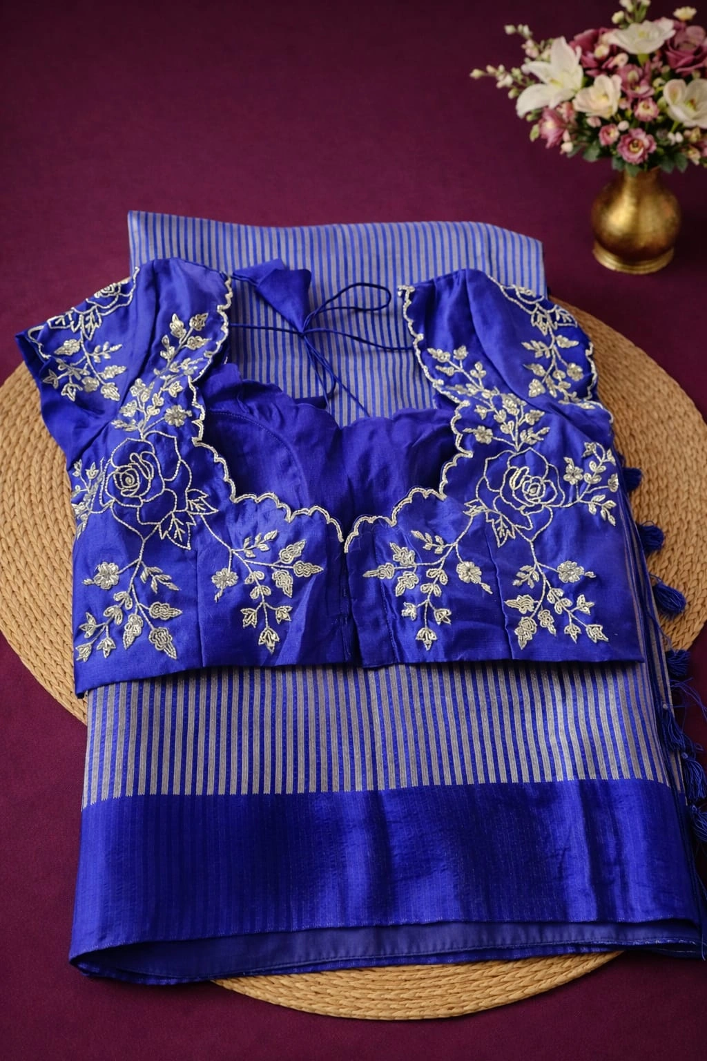 Pure Banarasi Kora tissue silk saree in royal blue with handwoven zari stripes, paired with an embroidered floral blouse.