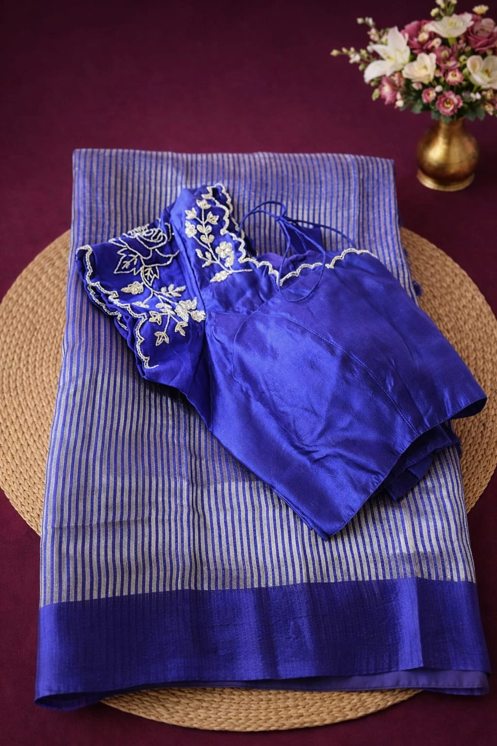 Pure Banarasi Kora tissue silk saree in royal blue with silver zari stripes, paired with an embroidered blue blouse.