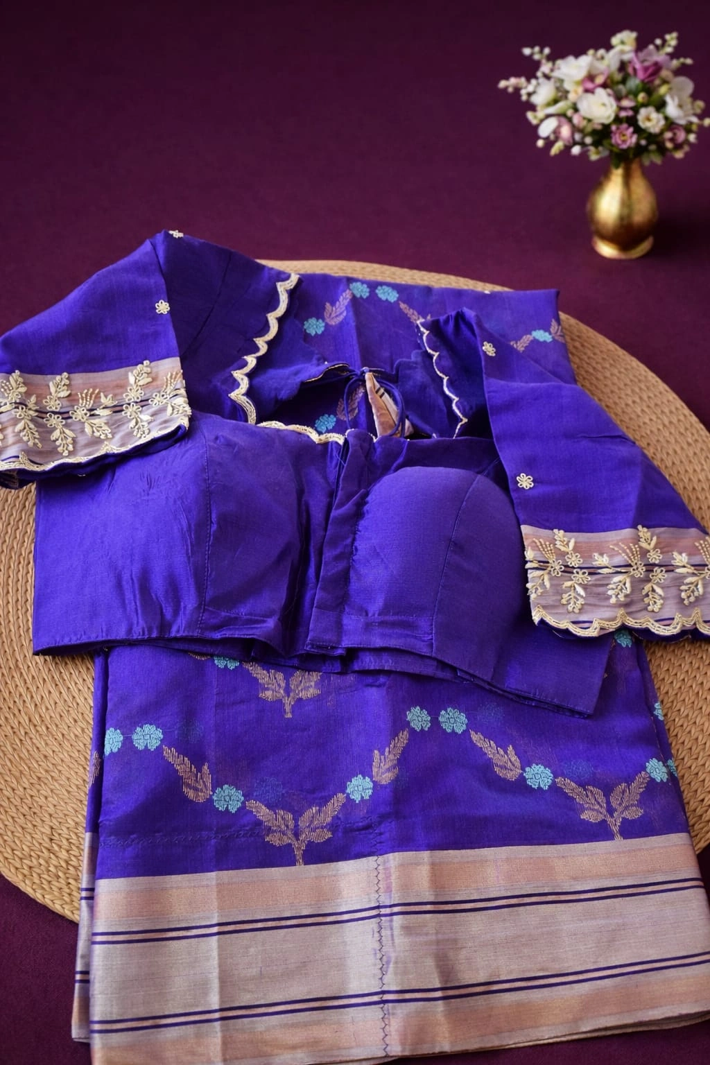 Handwoven pure Chanderi silk saree in royal purple with golden zari borders and floral motifs, paired with matching blouse.