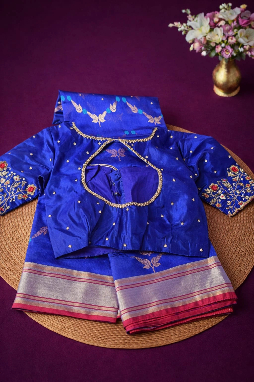 Handwoven pure Chanderi Pattu silk saree in royal blue with intricate zari work, floral embroidery, and silver border.