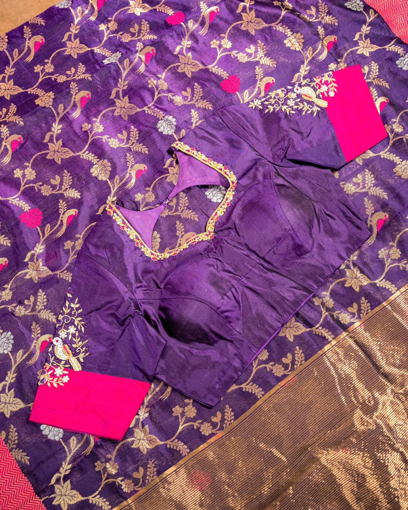 Pure Chanderi silk saree in deep purple with gold floral motifs, paired with a maggam work blouse featuring pink sleeves.