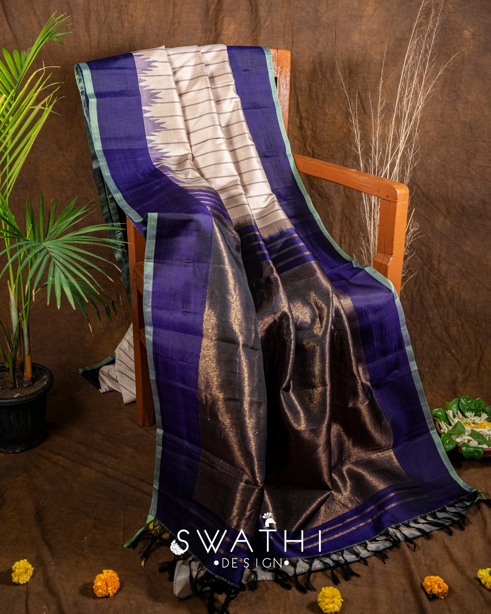 Pure Gadwal silk pattu saree in deep blue and black with silver zari border, paired with a handcrafted maggam work blouse.