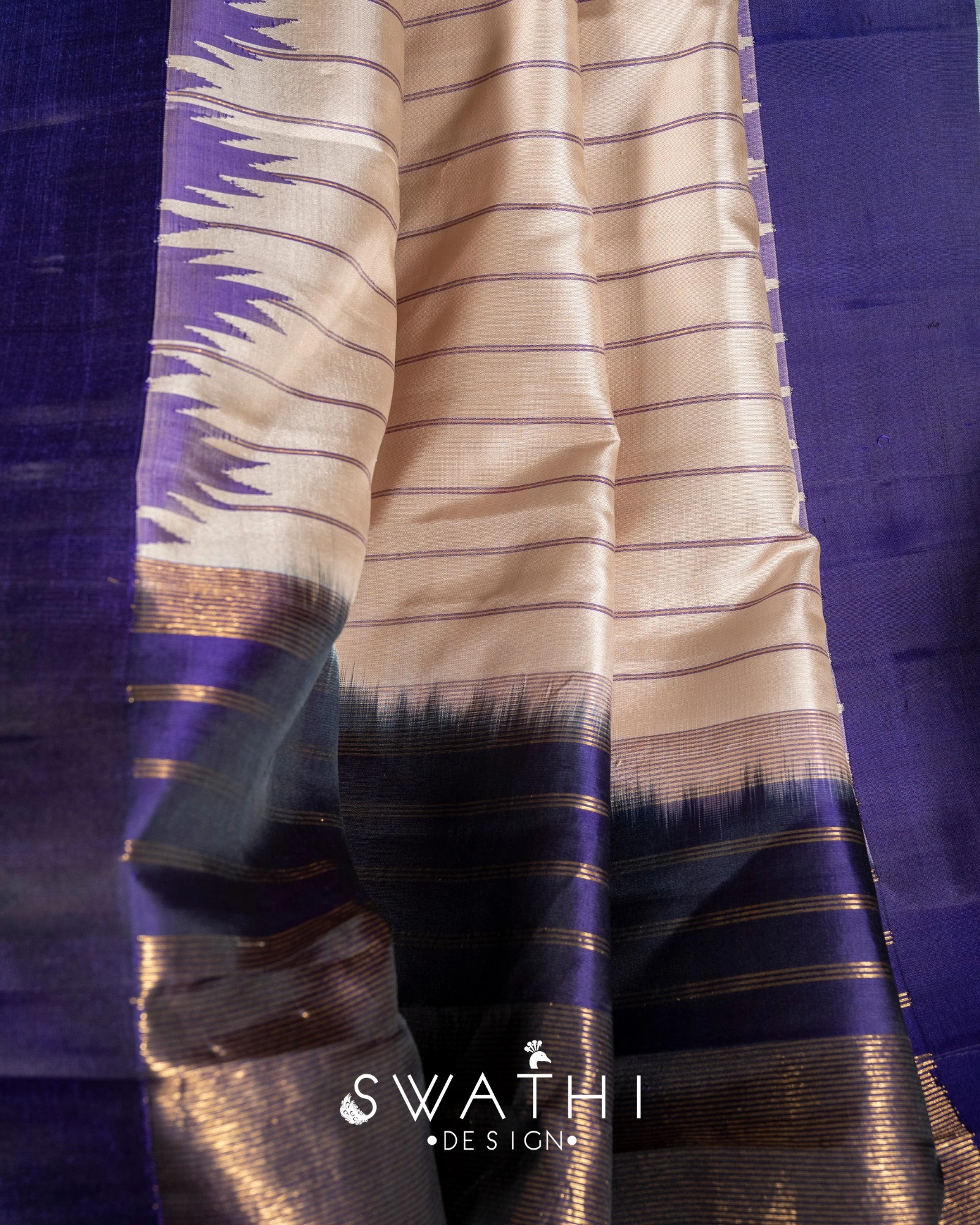 Pure Gadwal silk pattu saree in cream and royal purple with gold zari border and handcrafted maggam work blouse.